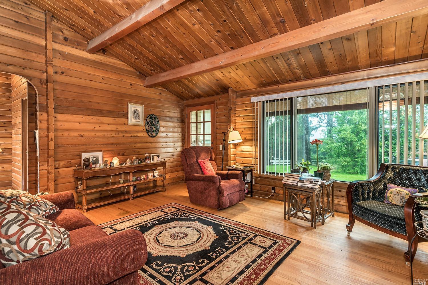 2466 Schaeffer Road Sebastopol, CA 95472 - Photo 1 of 1 a living room with furniture and a floor to ceiling window