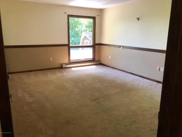 a view of an empty room with a window