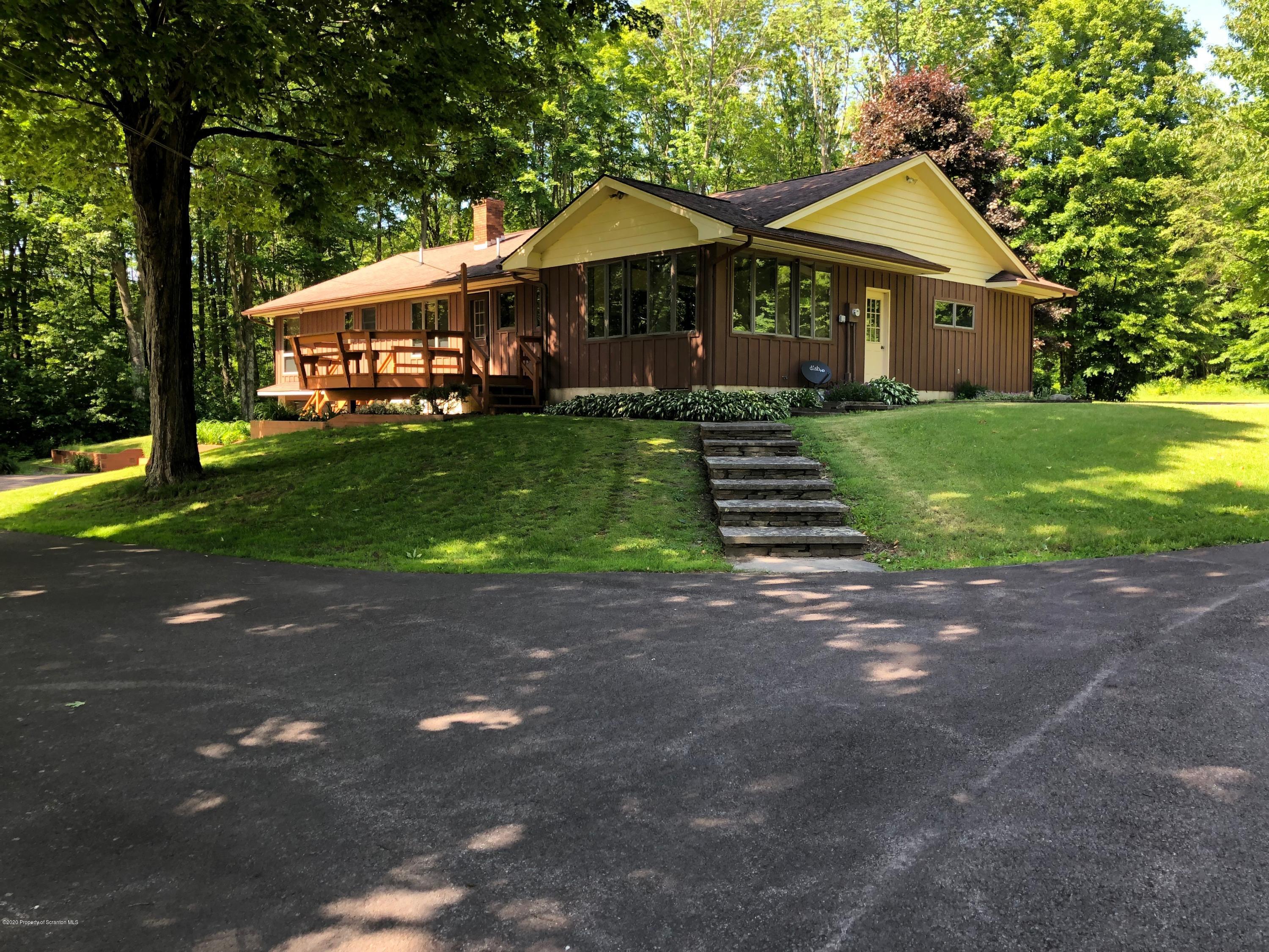 4262 Hamlin Highway Moscow, PA 18444 - Photo 2 of 13 a front view of a house with a yard