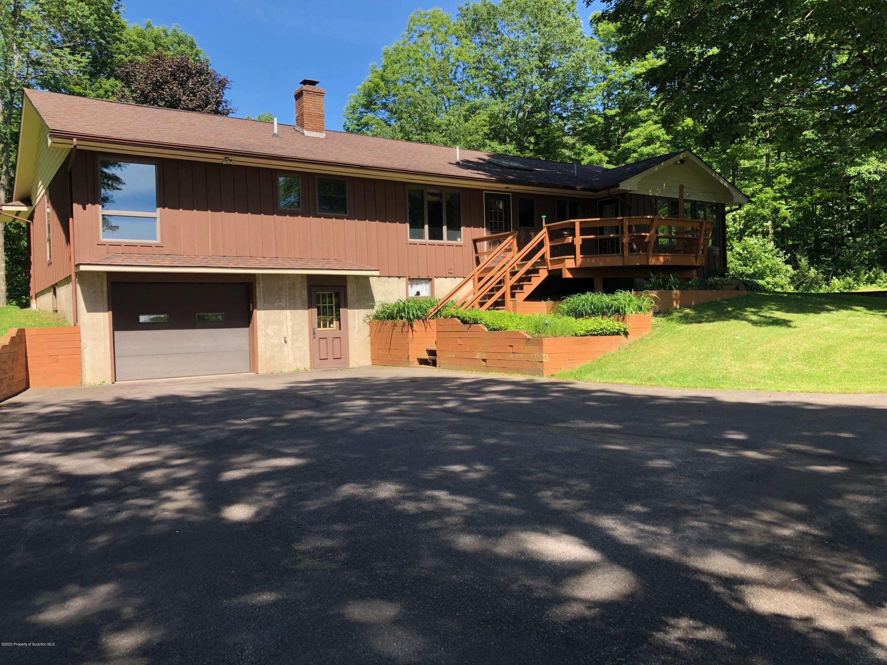 4262 Hamlin Highway Moscow, PA 18444 - Photo 4 of 13 a front view of a house with a yard