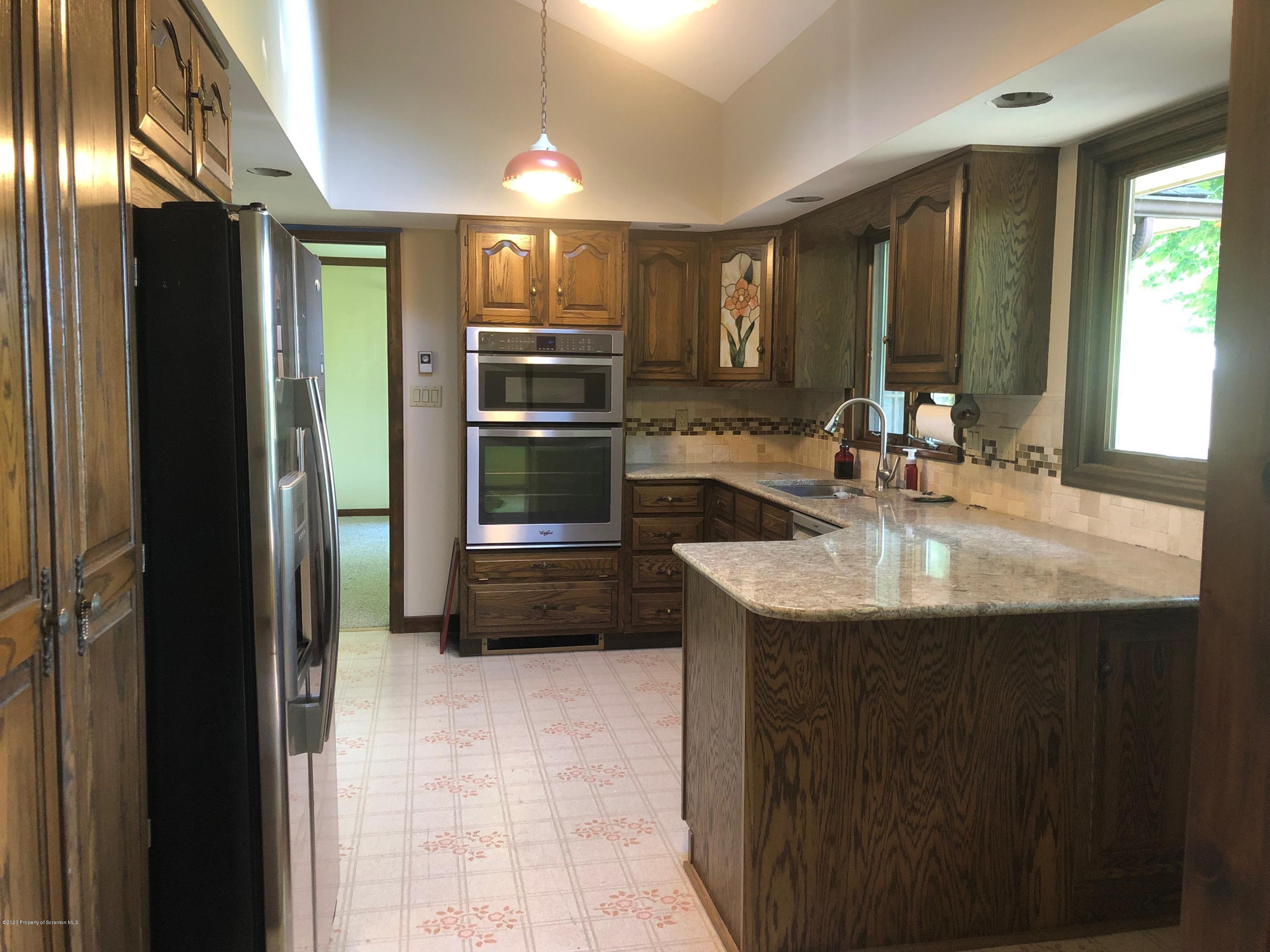 4262 Hamlin Highway Moscow, PA 18444 - Photo 6 of 13 a kitchen with kitchen island a sink appliances and cabinets