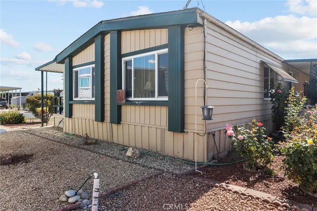 a view of a house with a small yard and wooden floor and fence