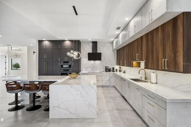 a large white kitchen with a large window