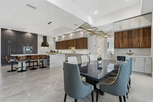 a dining room with furniture and a flat screen tv