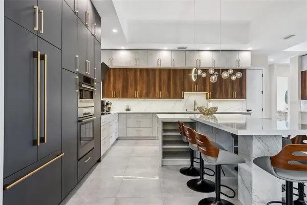 a kitchen with a sink appliances and cabinets