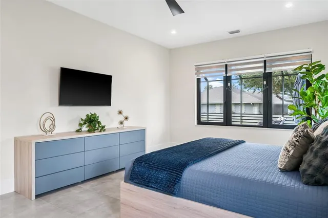a bathroom with a granite countertop sink a toilet a mirror and shower