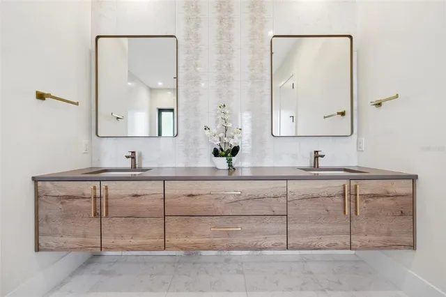 a kitchen with white cabinets a sink and a window
