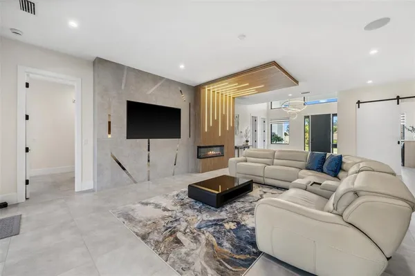 a living room with furniture and a flat screen tv