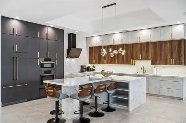 a kitchen with kitchen island a sink stove and refrigerator