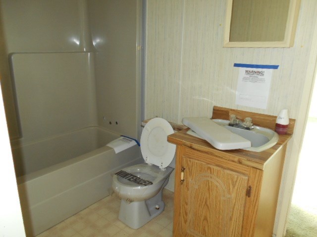 5654 Fulton Mill Road Lizella, GA 31052 - Photo 11 of 12 a bathroom with a sink a toilet and shower