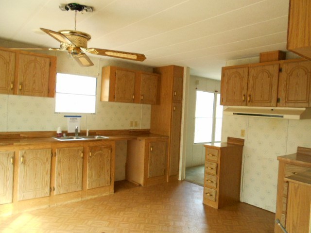 5654 Fulton Mill Road Lizella, GA 31052 - Photo 5 of 12 a kitchen with stainless steel appliances granite countertop a refrigerator and a stove top oven