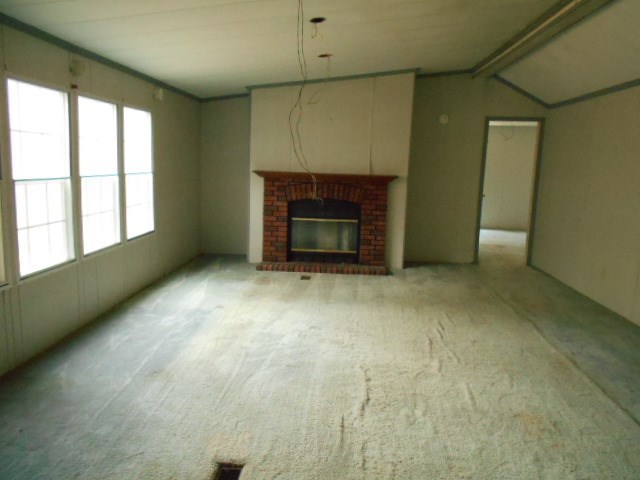 5654 Fulton Mill Road Lizella, GA 31052 - Photo 6 of 12 a view of an empty room with a fireplace and a window