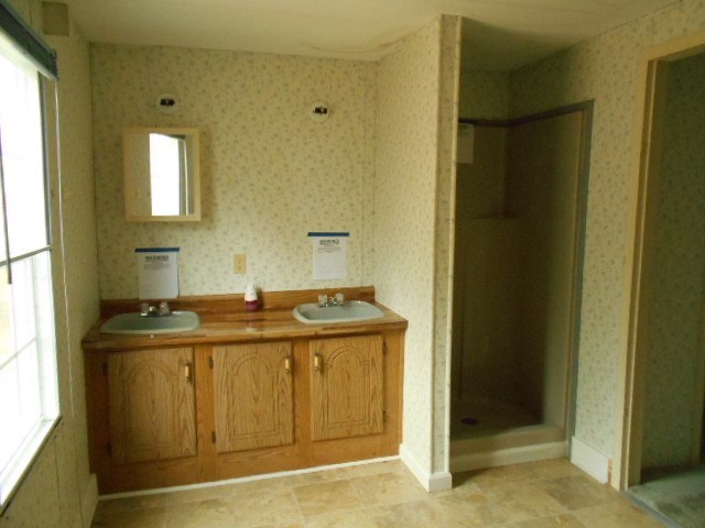 5654 Fulton Mill Road Lizella, GA 31052 - Photo 9 of 12 a bathroom with a granite countertop sink and a mirror