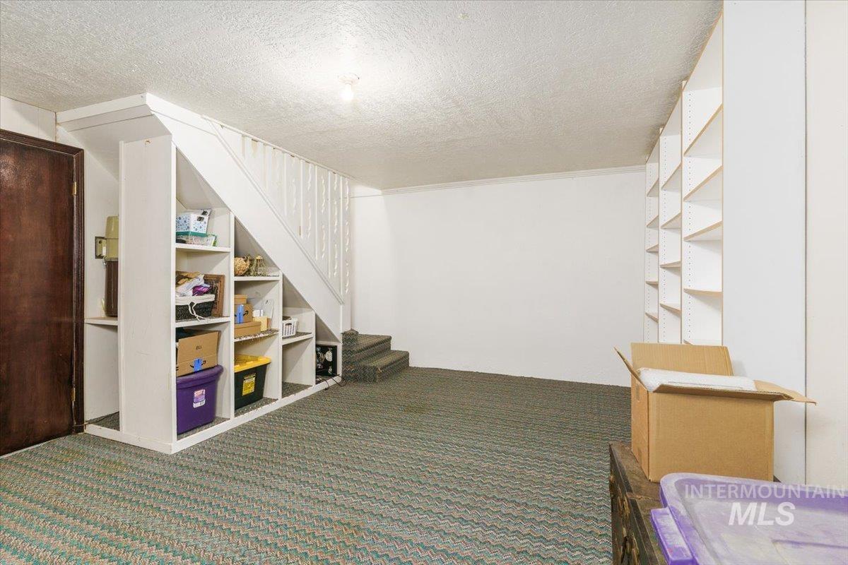 1401 Chokecherry Drive Pocatello, ID 83204 - Photo 35 of 46 Built-in under-stair shelving offers integrated storage, complemented by a full wall of adjustable shelving units