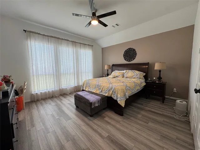 a bedroom with a bed dresser and a window