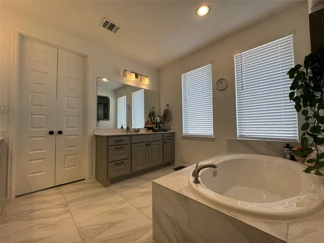 a bathroom with a bathtub and a sink