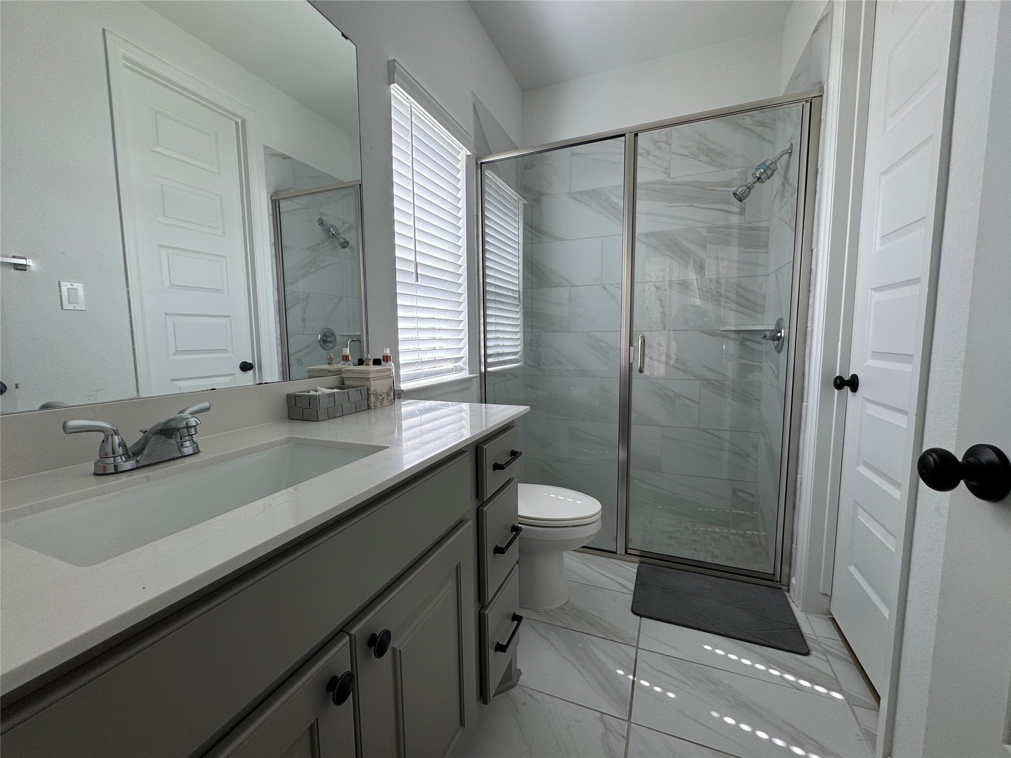 4522 Peloton Road Rosharon, TX 77583 - Photo 3 of 19 a bathroom with a double vanity sink toilet and shower