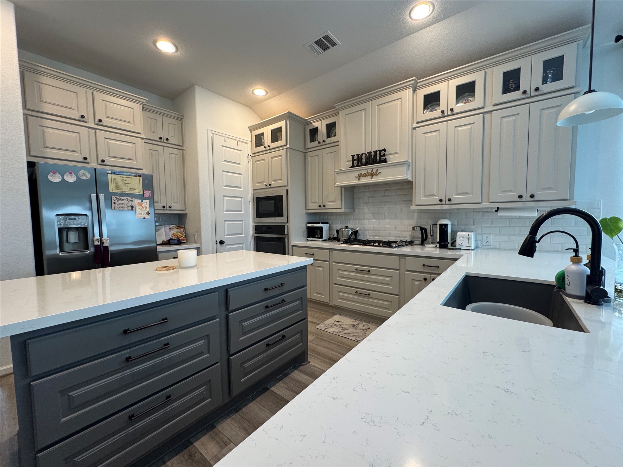 4522 Peloton Road Rosharon, TX 77583 - Photo 7 of 19 a kitchen with stainless steel appliances sink a stove and cabinets