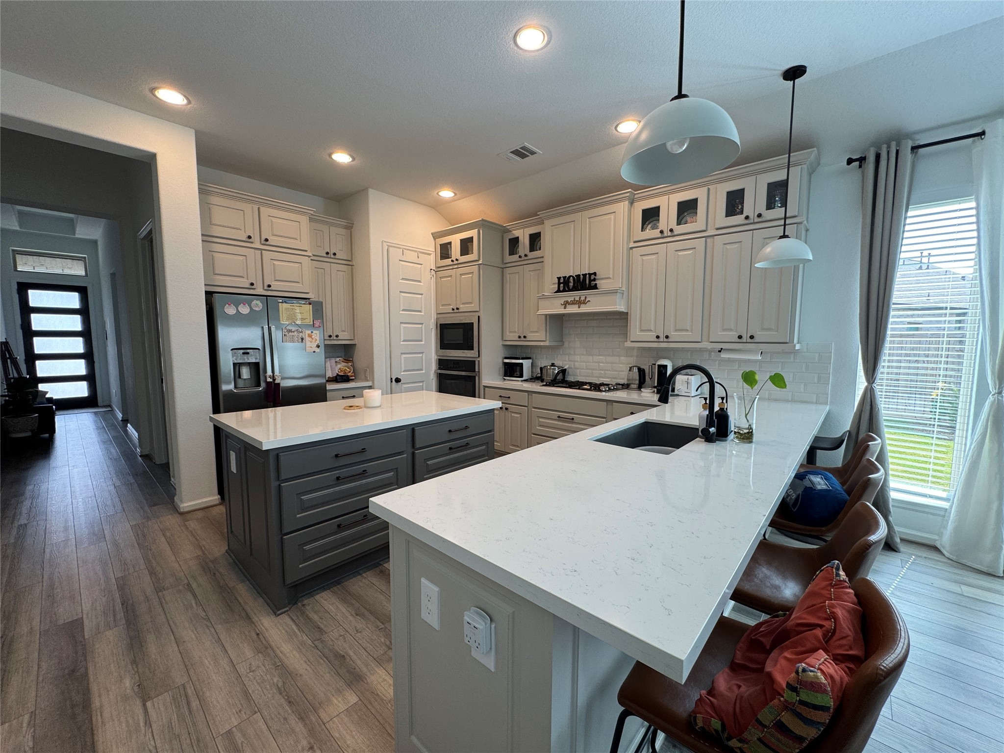 4522 Peloton Road Rosharon, TX 77583 - Photo 8 of 19 a large kitchen with sink a refrigerator and chairs