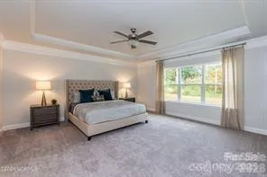 a spacious bedroom with a bed and window