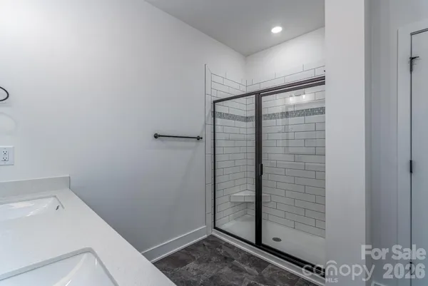 a bathroom with a shower and closet