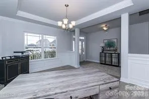 a view of a kitchen with stainless steel appliances granite countertop wooden floor and a window