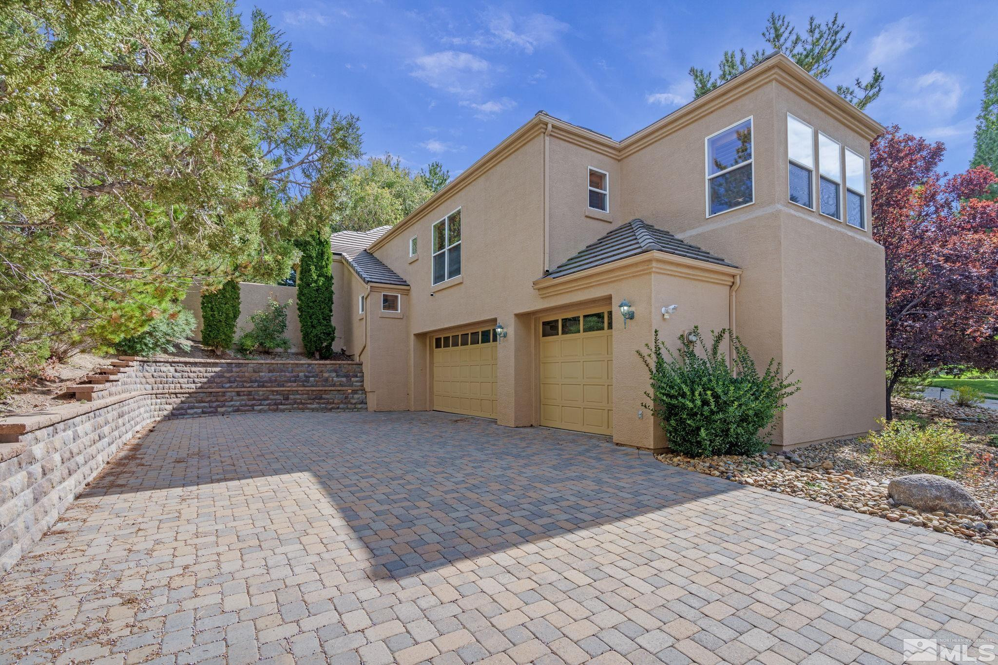 3950 Plateau Road Reno, NV 89519 - Photo 1 of 37 a front view of a house with a yard and a garage