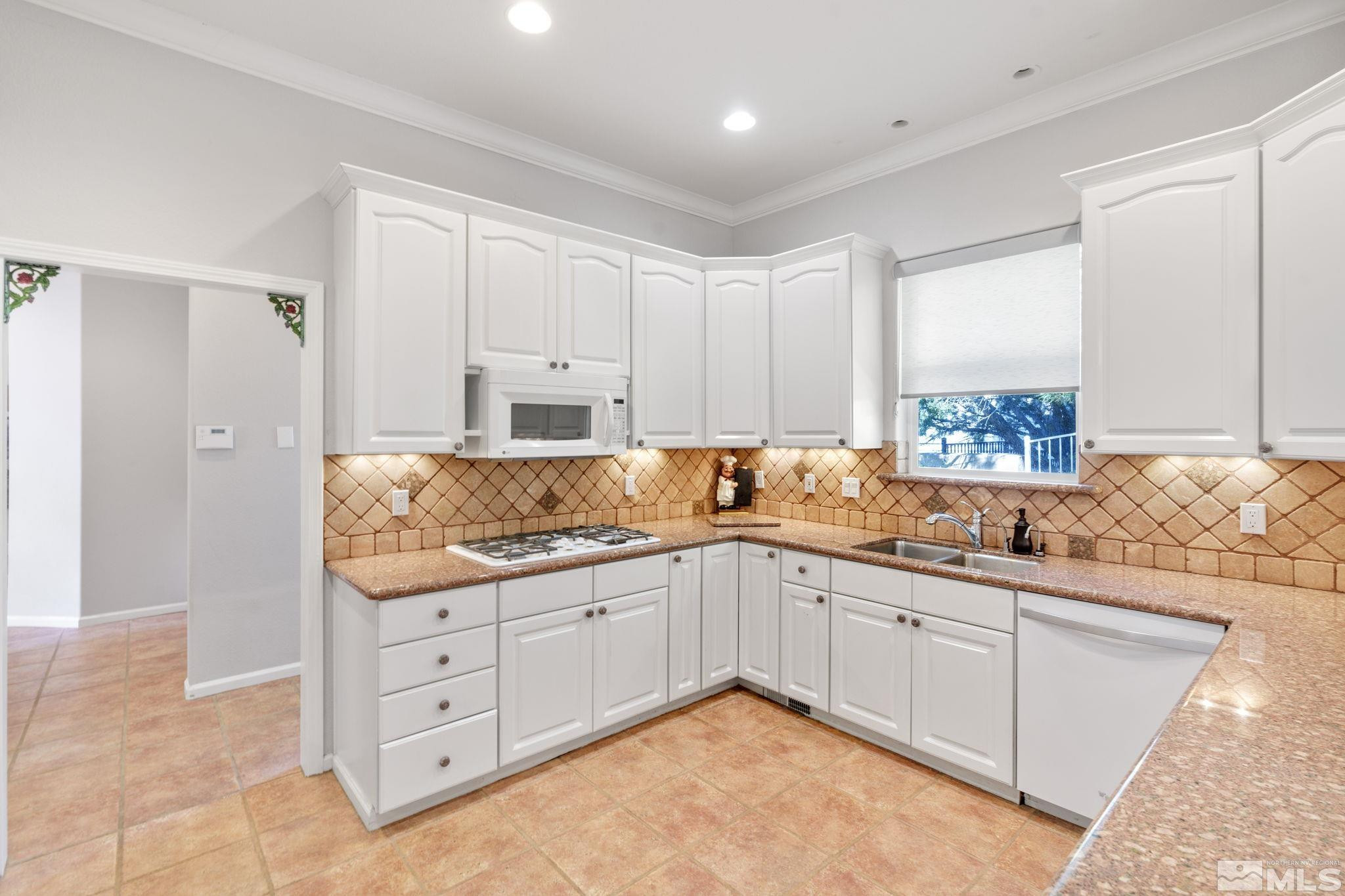 3950 Plateau Road Reno, NV 89519 - Photo 13 of 37 a kitchen with granite countertop a sink and cabinets