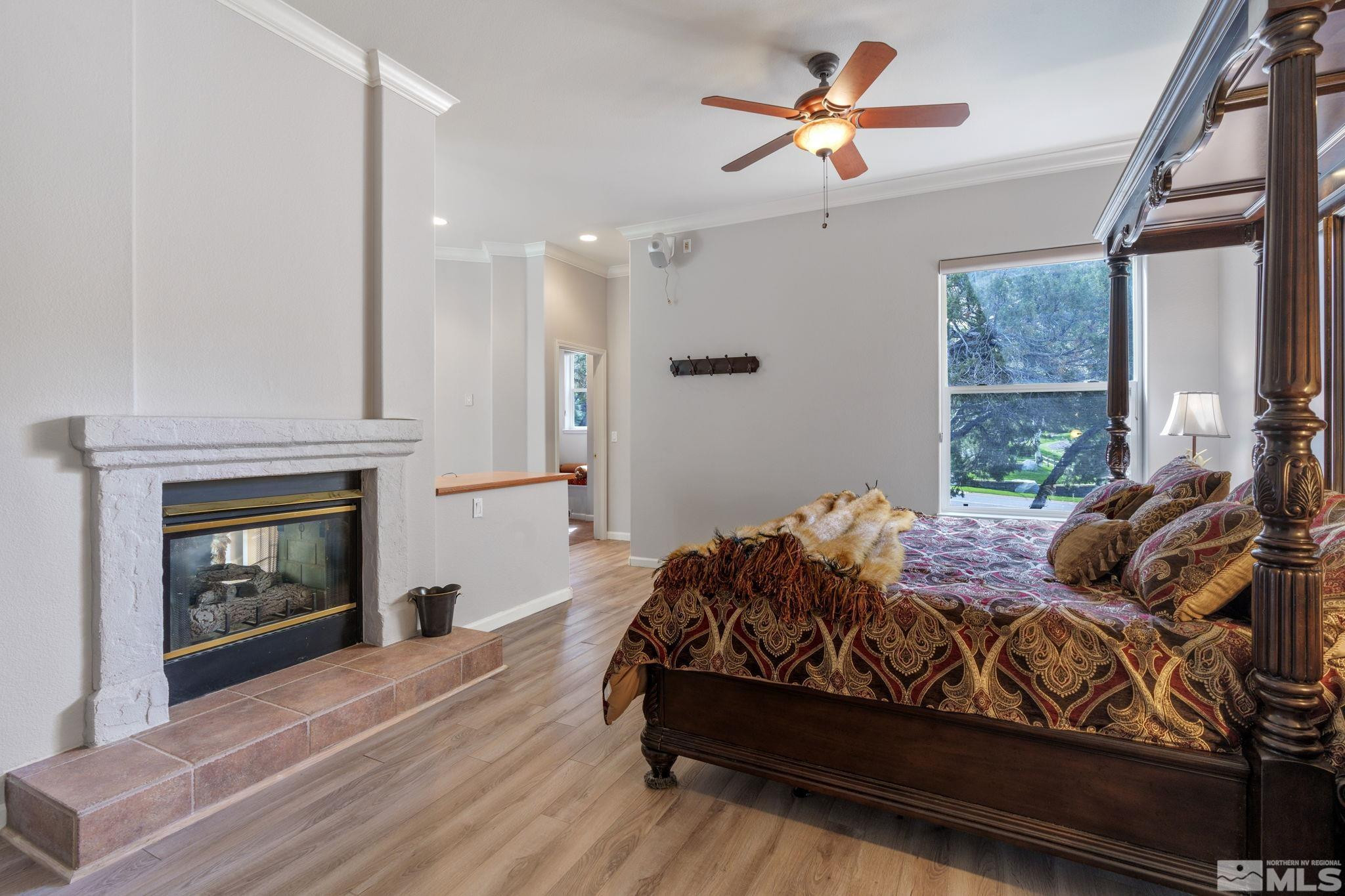 3950 Plateau Road Reno, NV 89519 - Photo 18 of 37 a bedroom with a bed and a fireplace
