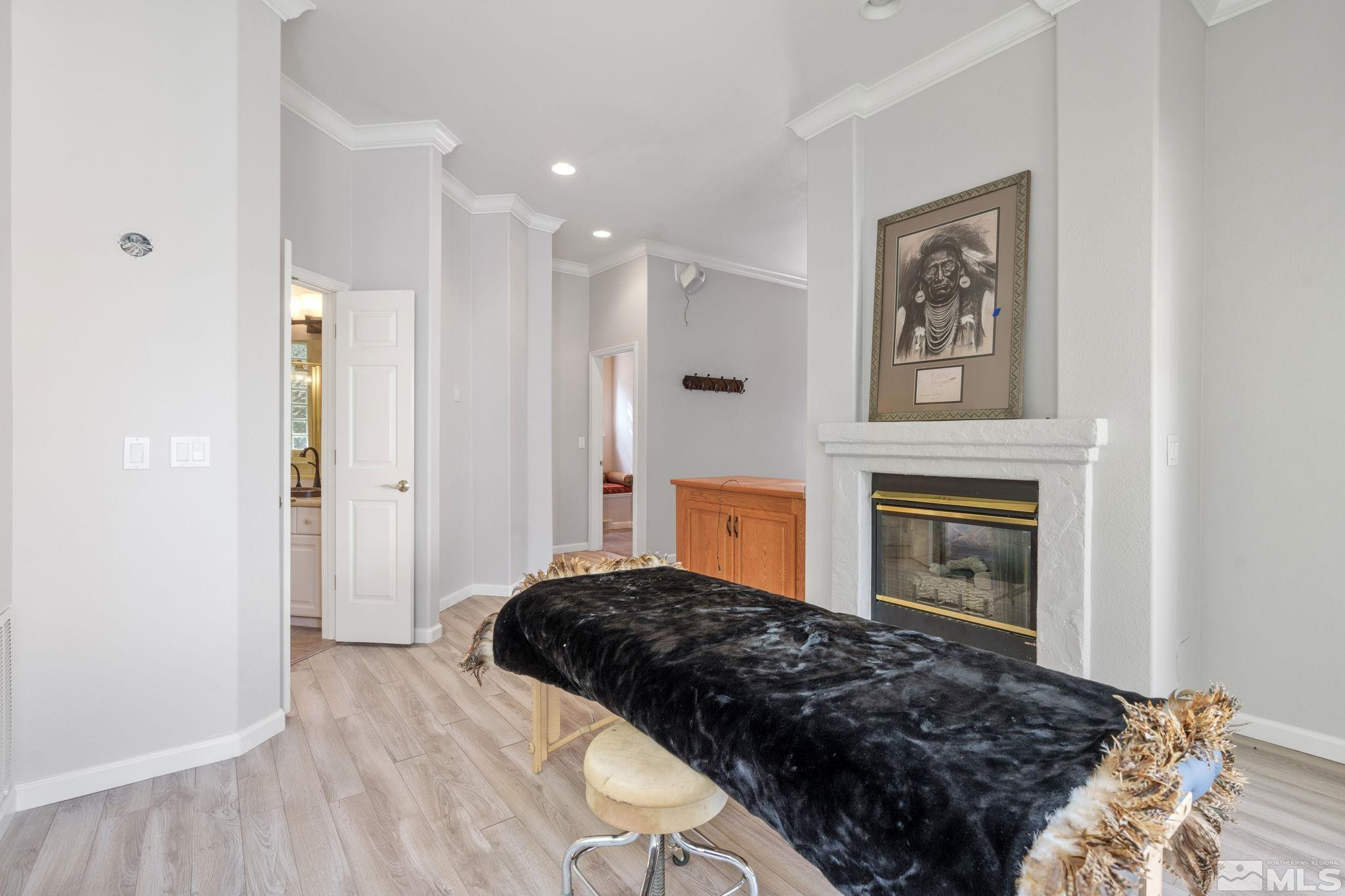 3950 Plateau Road Reno, NV 89519 - Photo 21 of 37 a bedroom with a bed and a fireplace