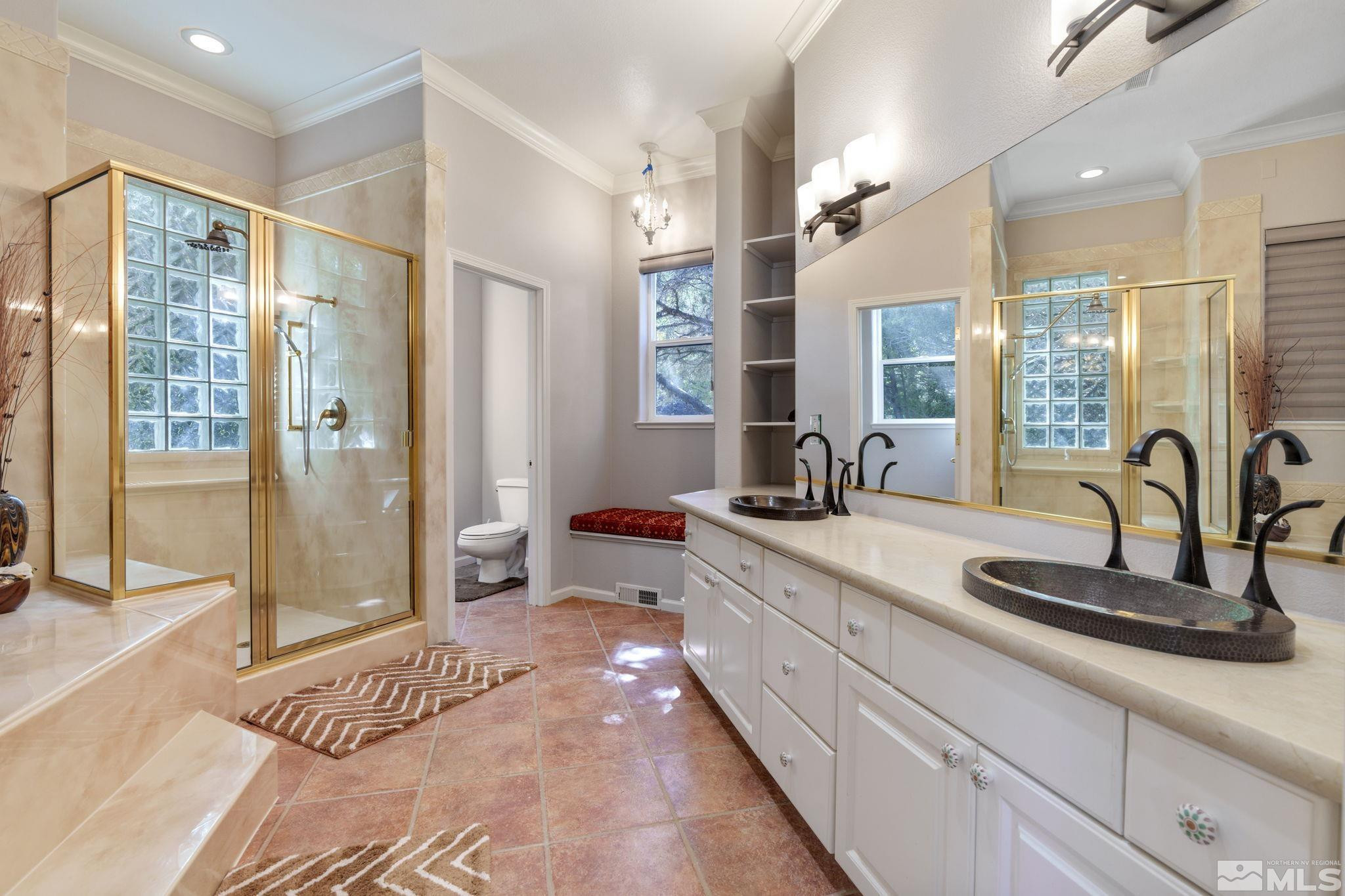 3950 Plateau Road Reno, NV 89519 - Photo 22 of 37 a spacious bathroom with a double vanity sink a large mirror a shower and a bathtub
