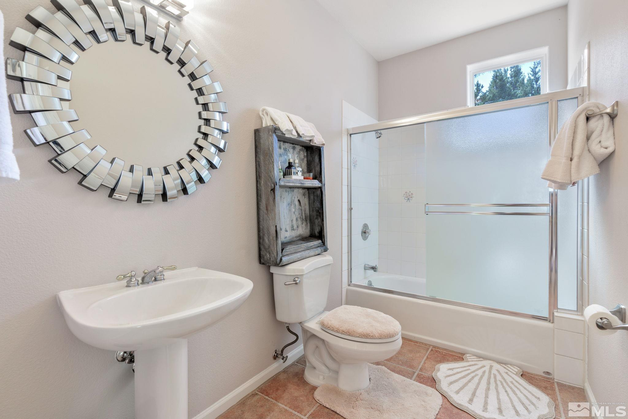 3950 Plateau Road Reno, NV 89519 - Photo 27 of 37 a bathroom with a sink a toilet and shower