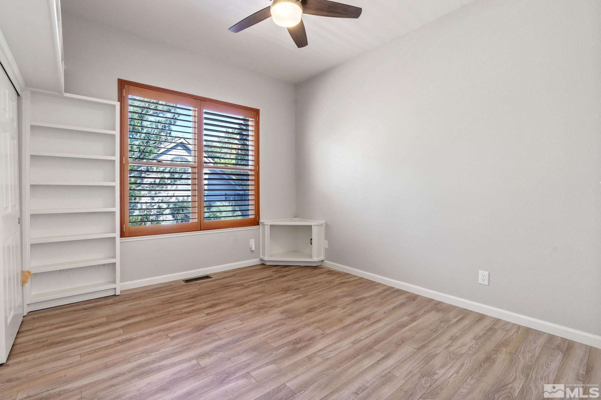 3950 Plateau Road Reno, NV 89519 - Photo 30 of 37 a view of an empty room with a window and wooden floor