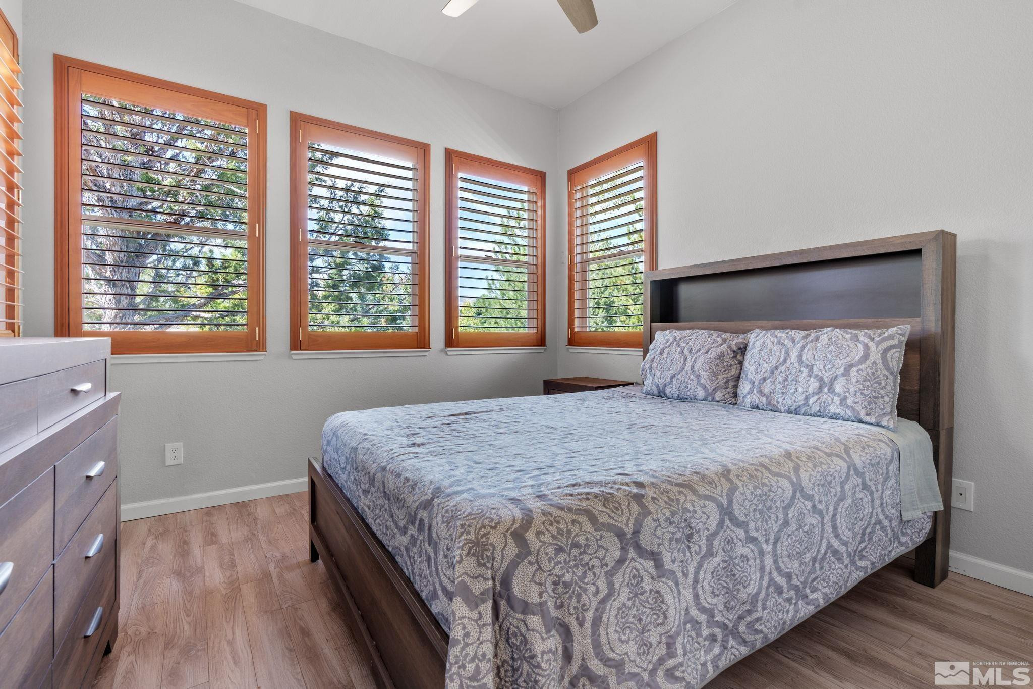 3950 Plateau Road Reno, NV 89519 - Photo 31 of 37 a bedroom with a large bed and a large window