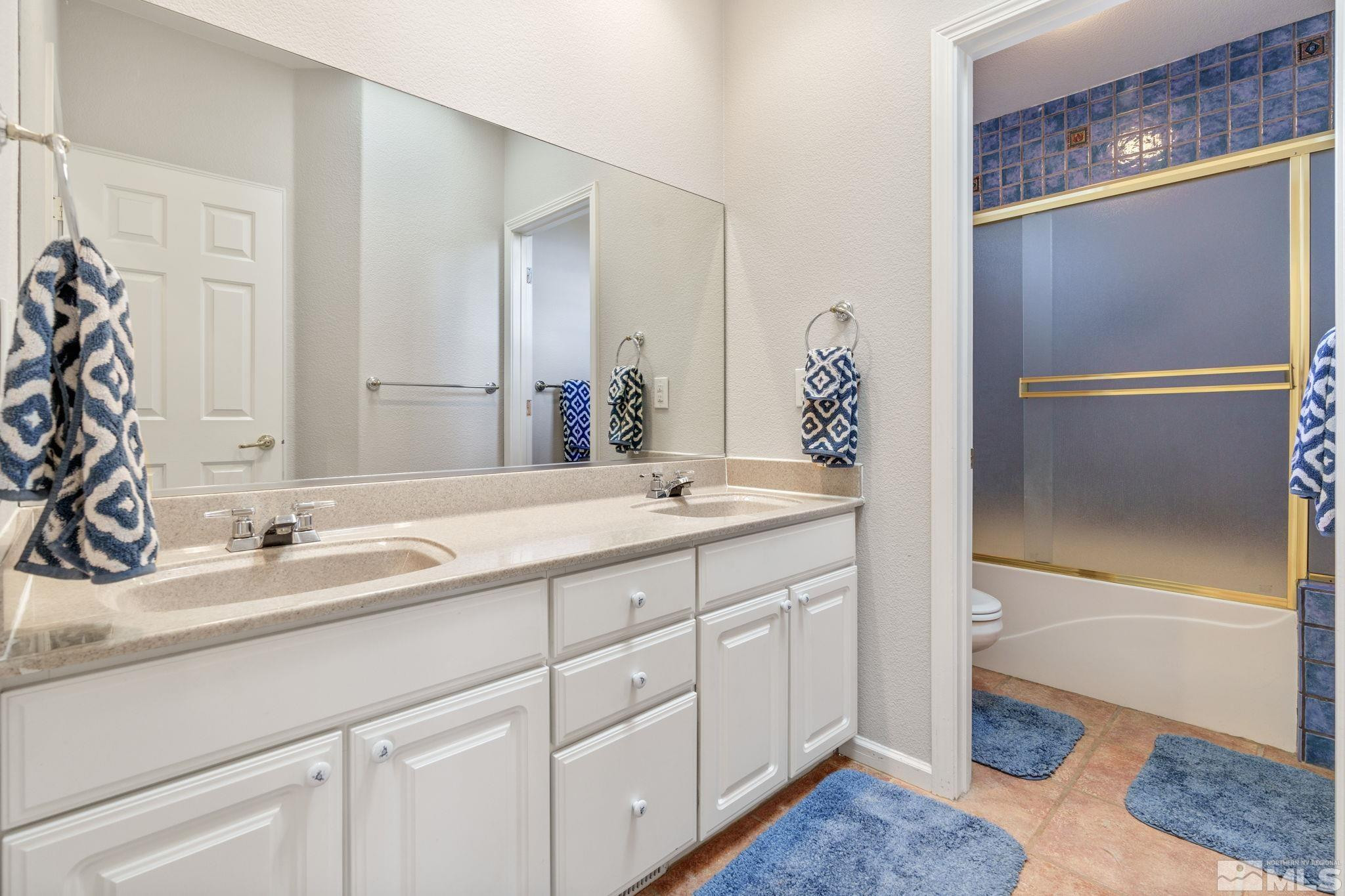 3950 Plateau Road Reno, NV 89519 - Photo 32 of 37 a bathroom with a double vanity sink and a mirror
