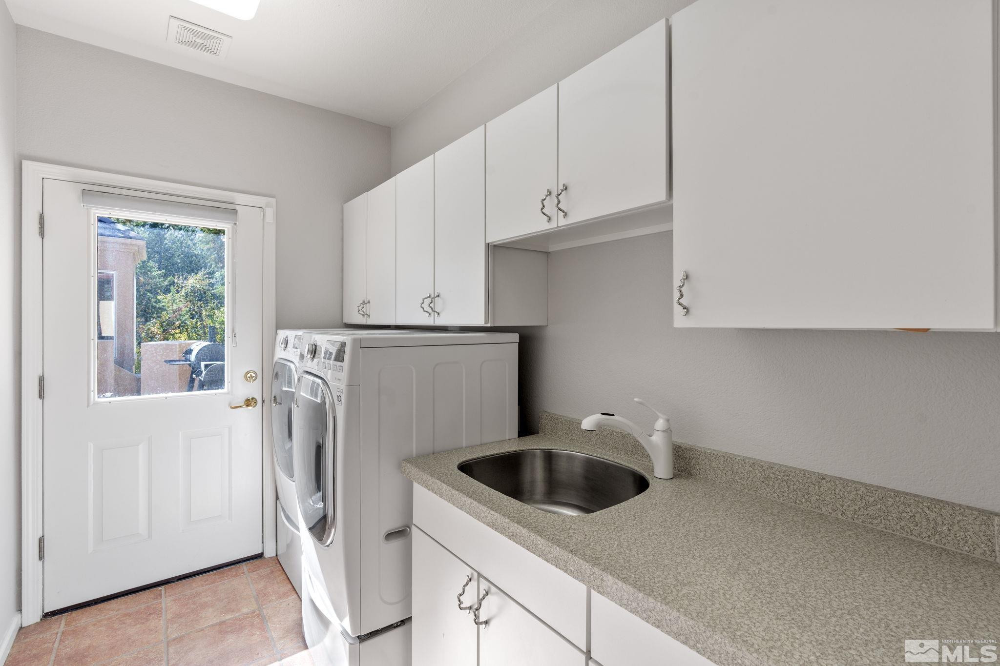 3950 Plateau Road Reno, NV 89519 - Photo 33 of 37 a kitchen with white cabinets and white appliances