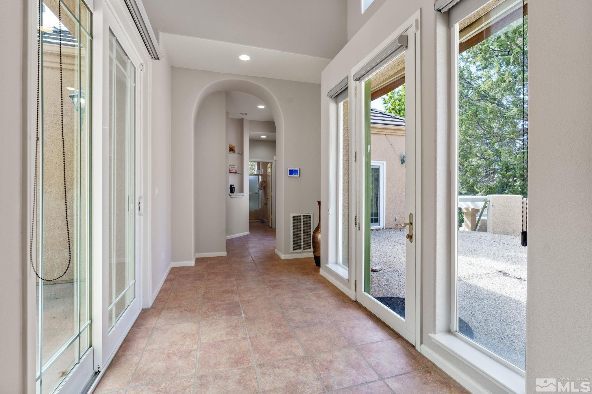 3950 Plateau Road Reno, NV 89519 - Photo 6 of 37 a view of a hallway with wooden floor and windows