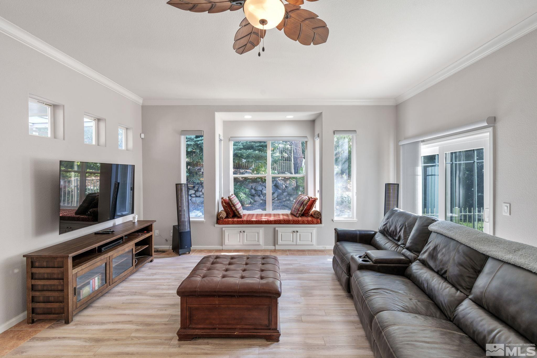 3950 Plateau Road Reno, NV 89519 - Photo 10 of 37 a living room with furniture a flat screen tv and a large window