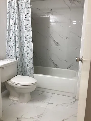 a bathroom with a toilet and a bathtub