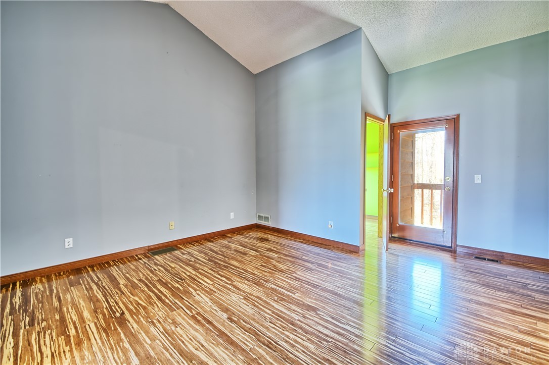 8711 Nicole Lane Springboro, OH 45066 - Photo 39 of 87 This versatile room features warm wood flooring and a door leading to outdoor space.