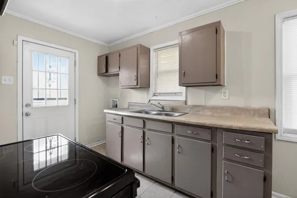 a kitchen with sink and cabinets