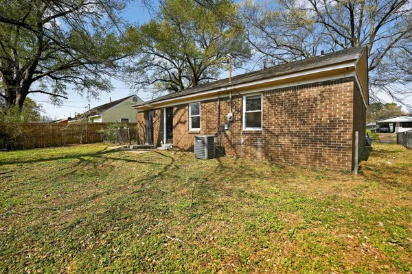 a view of a yard with wooden fence