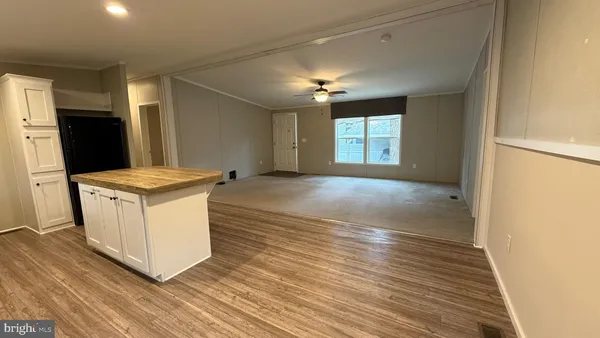 a view of kitchen cabinets and wooden floor