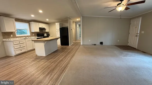 a large kitchen with kitchen island a sink stainless steel appliances and cabinets