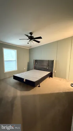 a bedroom with a bed and window