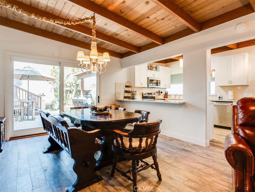 430 Olive Street Morro Bay, CA 93442 - Photo 23 of 68 a dining room with furniture a chandelier and wooden floor
