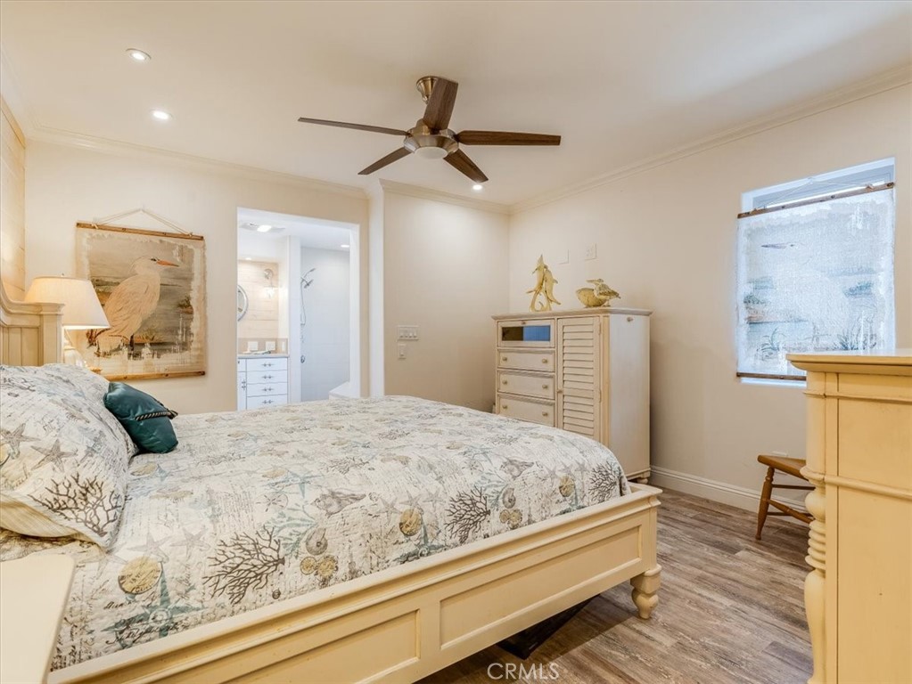 430 Olive Street Morro Bay, CA 93442 - Photo 36 of 68 a bedroom with a bed and wooden floor