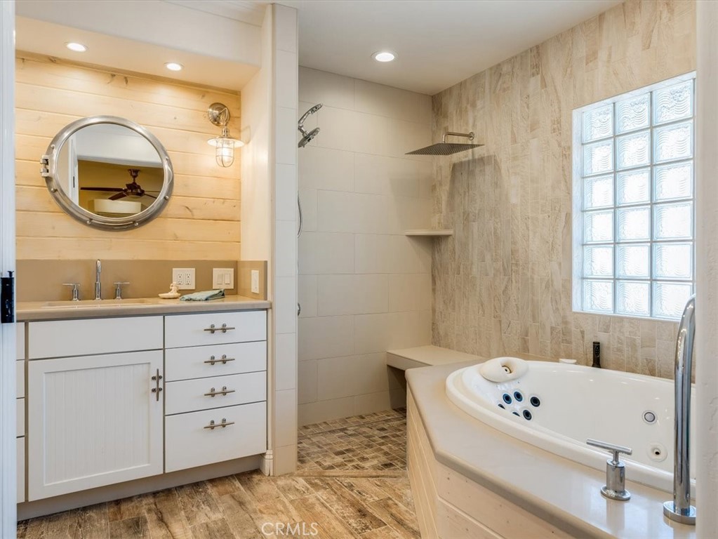 430 Olive Street Morro Bay, CA 93442 - Photo 40 of 68 a bathroom with a tub a sink and a mirror
