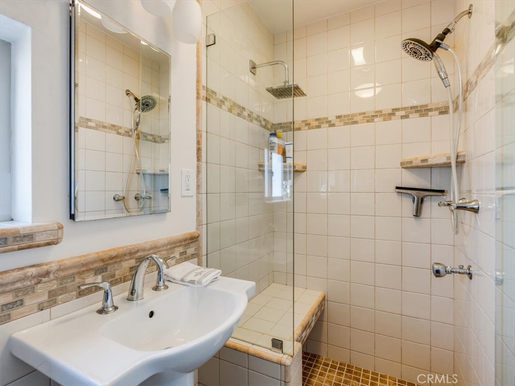 430 Olive Street Morro Bay, CA 93442 - Photo 46 of 68 a bathroom with a sink a shower and a mirror