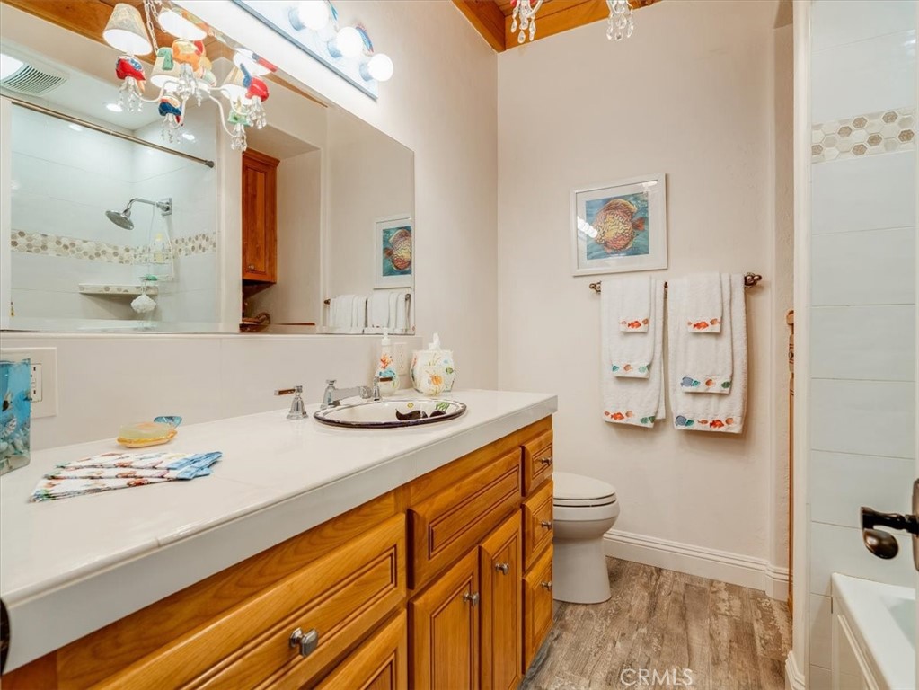 430 Olive Street Morro Bay, CA 93442 - Photo 50 of 68 a bathroom with a sink a toilet and shower curtain